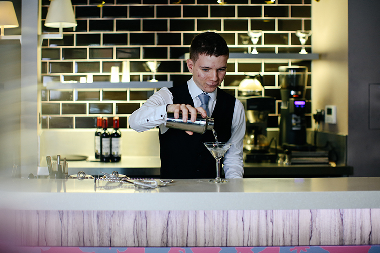 student pouring a drink
