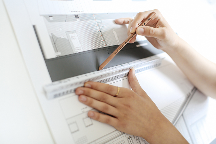 Student drawing a design