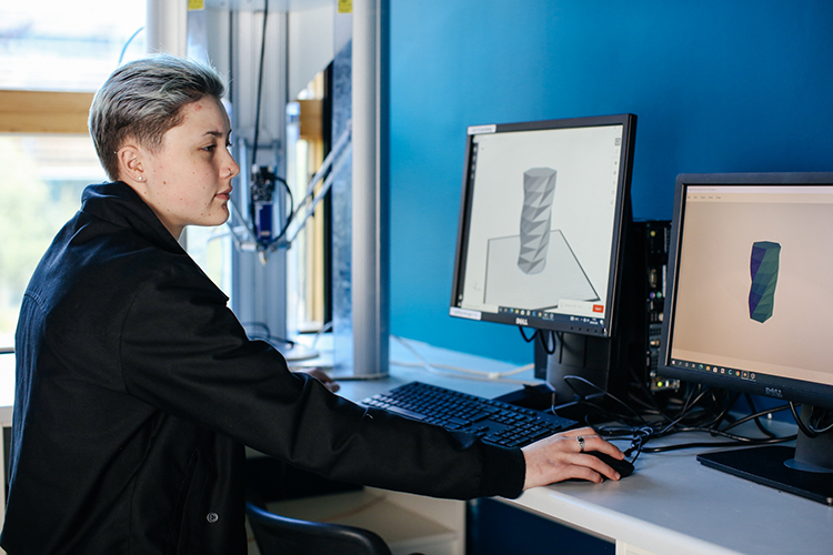 Student looking at 3D design on a computer