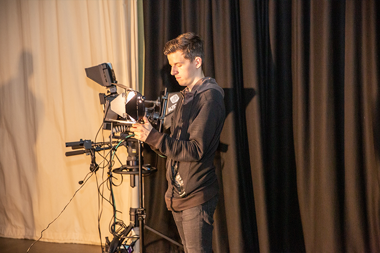Student setting up a camera