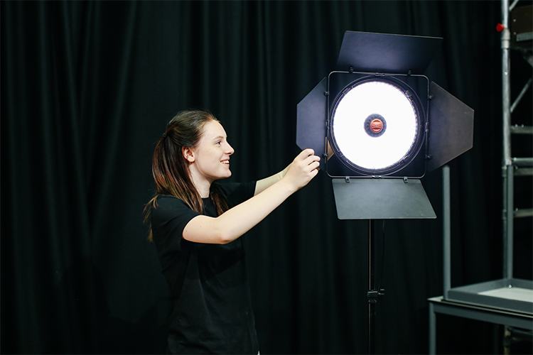 Student setting up a light