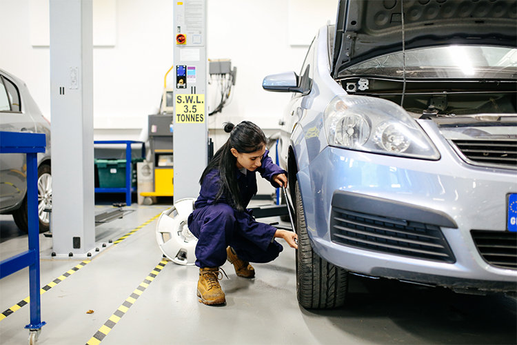 Student working on a car