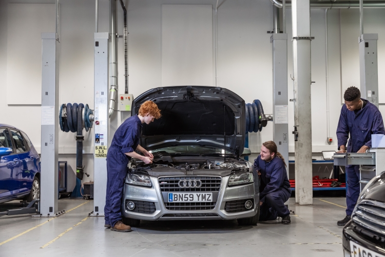 Students inspecting a car