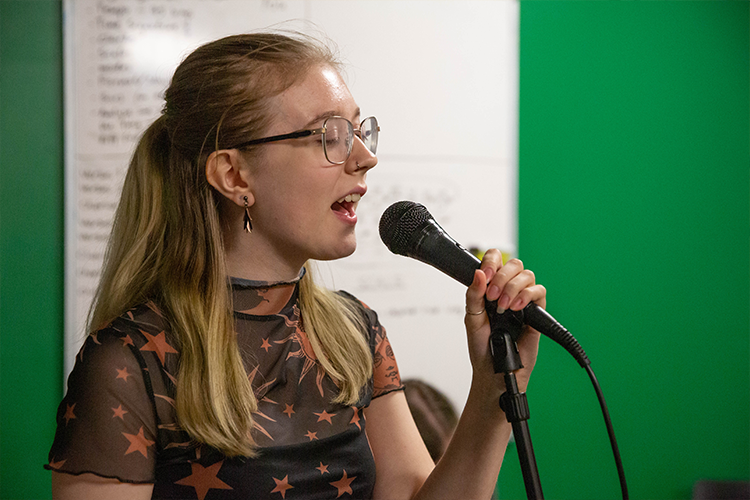 Student singing into a microphone