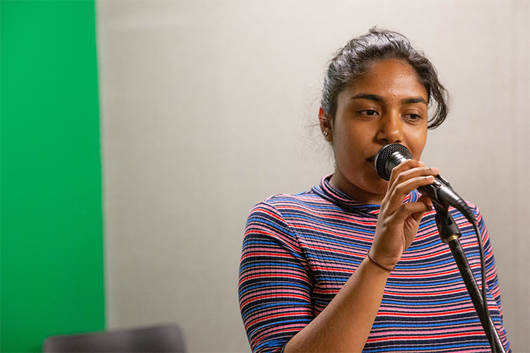 Student singing into a microphone