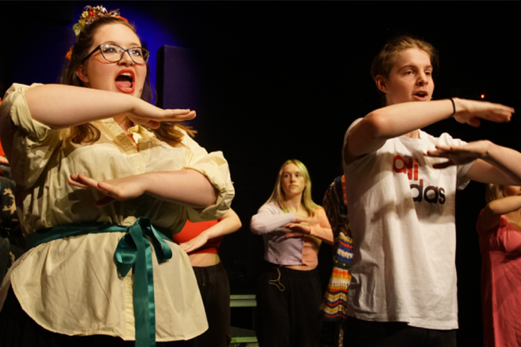Students singing on stage