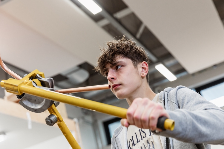 Student working on a plumbing project