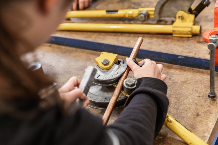 Student working on a plumbing project