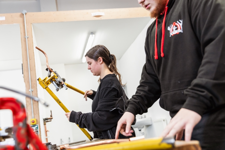 Student working on a plumbing project