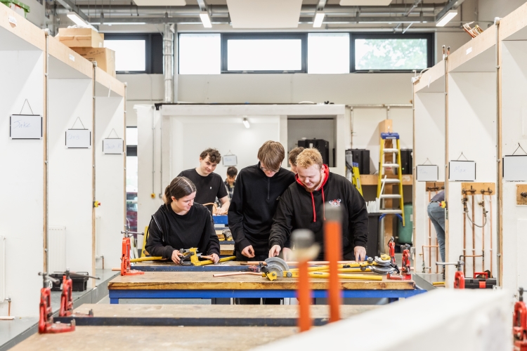 Students working on a plumbing project