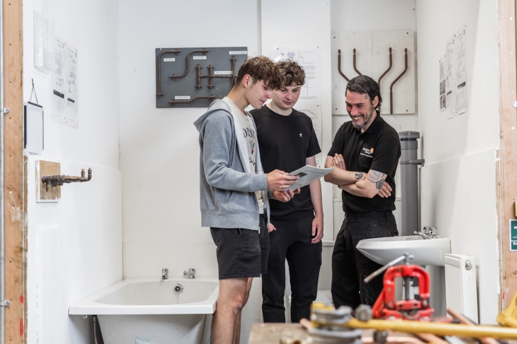 Tutor and students looking at a piece of paper
