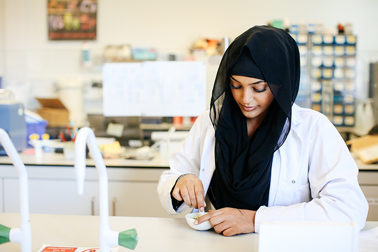 Student using a pestle and mortar