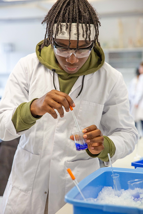 Student taking a sample from a beaker