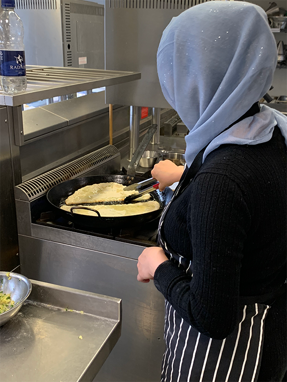 Afghan woman frying bread