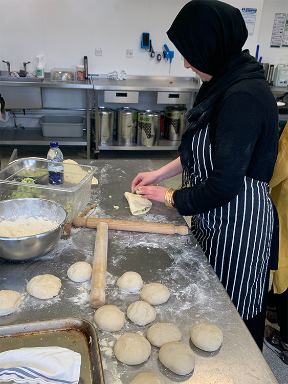 Afghan woman kneading bread