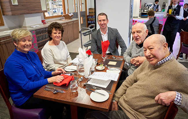 Mayor and diners smiling at camera