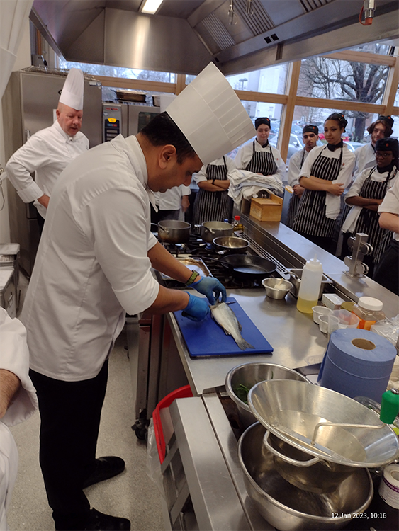 Wembley chef demonstrating filleting fish