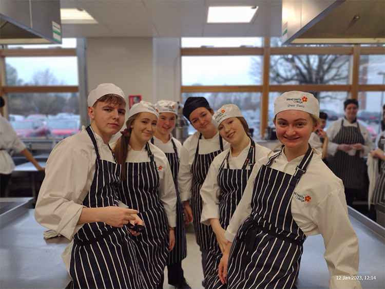 Professional cookery students smiling at camera
