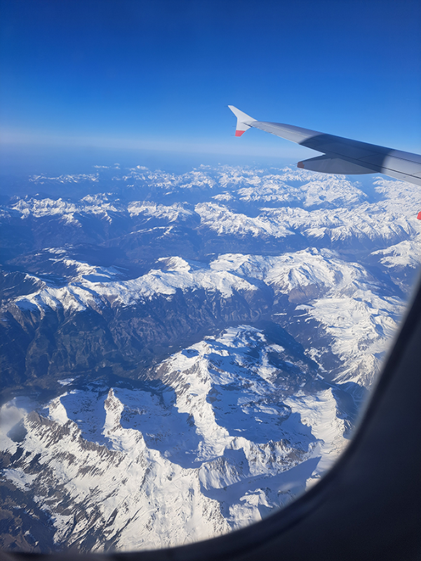 Aeroplane window looking over mountains