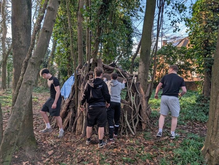 students building a den