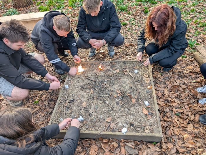students learning to start a fire