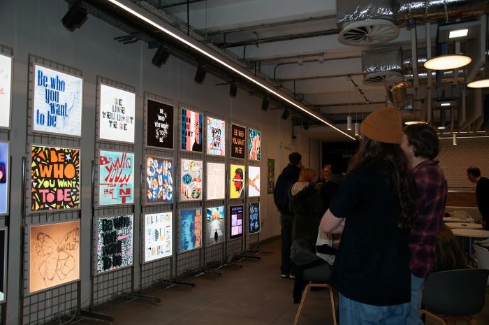 People looking at designs on display