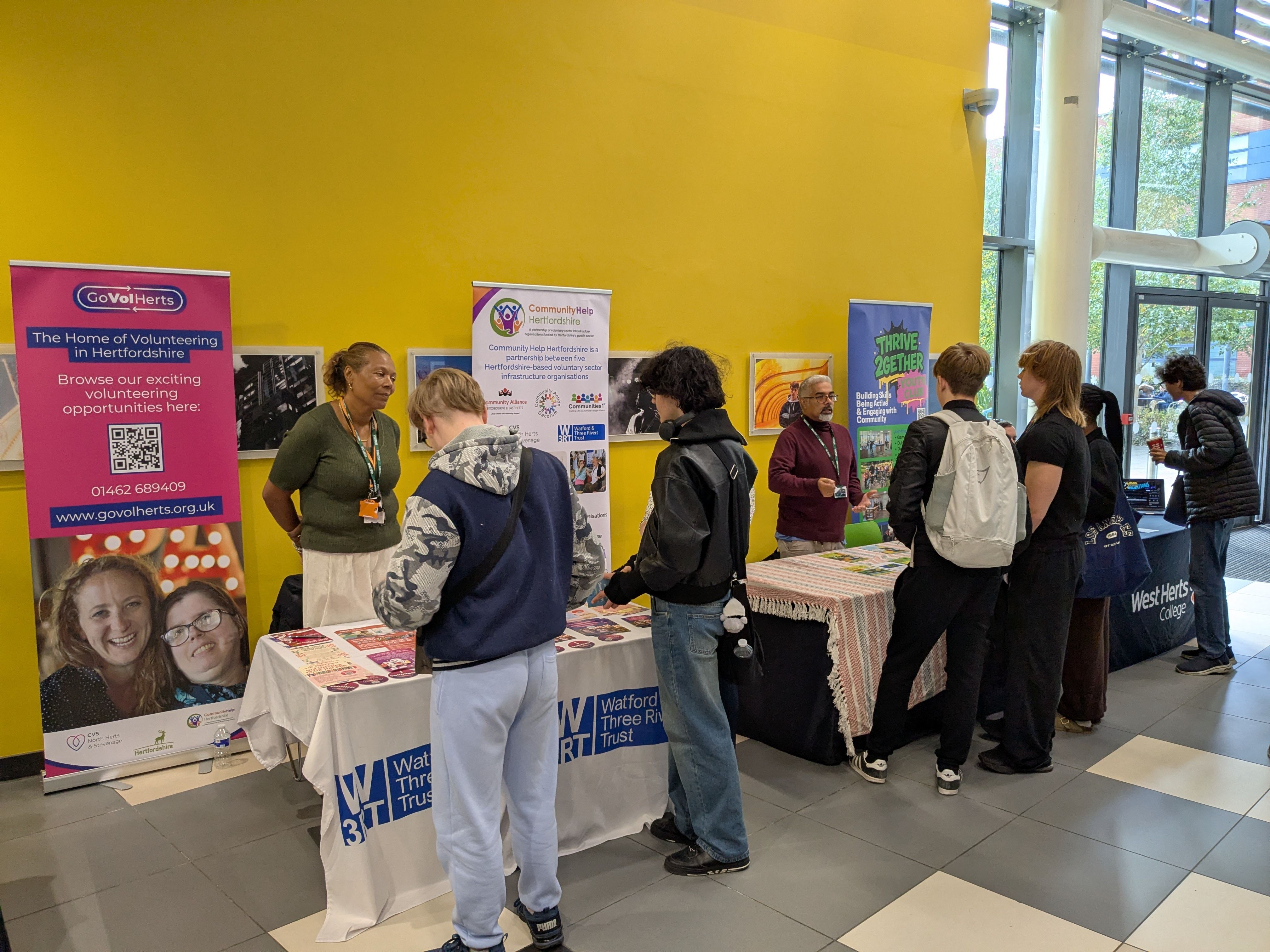 Students talking to exhibitors at Volunteers Fair